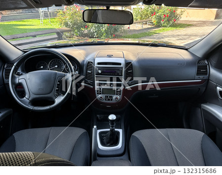 Inside view of a stylish car interior showcasing comfort and modern design during a sunny day in a vibrant garden setting Inside view of a stylish car interior showcasing comfort and modern design during a sunny day in a vibrant garden setting 132315686