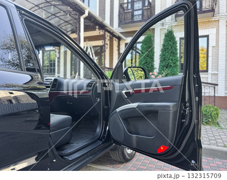 Elegant black car interior awaits on a sunny day in a residential area with a welcoming atmosphere 132315709