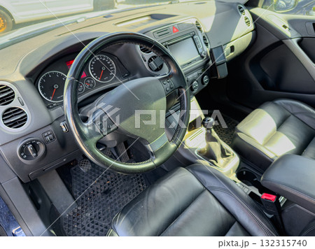 Interior view of a stylish car showcasing leather seats and modern dashboard details during daylight Interior view of a stylish car showcasing leather seats and modern dashboard details during daylight 132315740