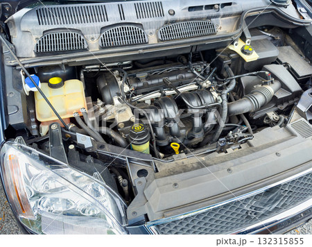 Exploring the intricate details of a car's engine compartment during a routine maintenance check in bright daylight 132315855