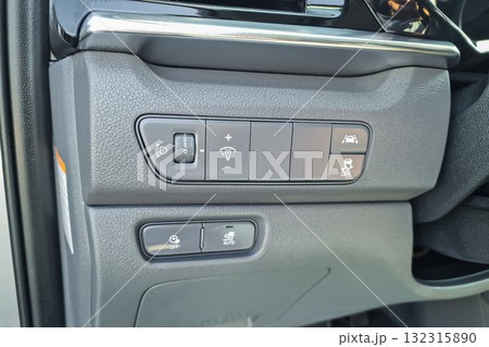 Control panel with various buttons for car features near the driver's seat in a modern vehicle, showcasing functionality for enhanced driving experience Control panel with various buttons for car features near the driver's seat in a modern vehicle, showcasing functionality for enhanced driving experience 132315890