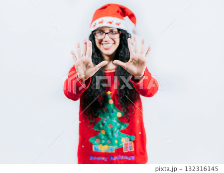 Happy girl in Christmas hat counting number TEN, isolated. Smiling girl in Christmas sweater counting number 10 Happy girl in Christmas hat counting number TEN, isolated. Smiling girl in Christmas sweater counting number 10 132316145