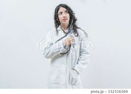 Doctor listening to her heart with stethoscope, isolated. Female doctor with stethoscope on her chest listening to her heart 132316269