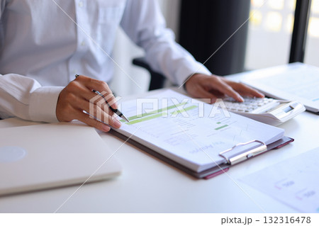 Businessman working in office reading documents analyze data for project planning. Businessman working in office reading documents analyze data for project planning. 132316478