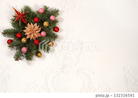 Beautiful holiday decoration made of live fir branches and toys isolated on a bright background, Christmas template for design, Christmas composition and New Year 2026 concept, banner for winter 132316591