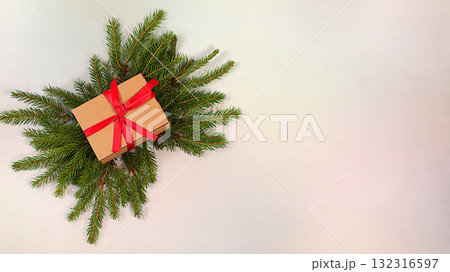 Beautiful Christmas and New Year background with gift box and live fir branches,Holiday winter greeting card and banner for screen,mockup for holiday advertising design,Christmas Eve concept Beautiful Christmas and New Year background with gift box and live fir branches,Holiday winter greeting card and banner for screen,mockup for holiday advertising design,Christmas Eve concept 132316597