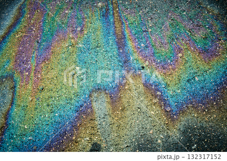 Oil spill forming colorful iridescent patterns on dark asphalt pavement 132317152