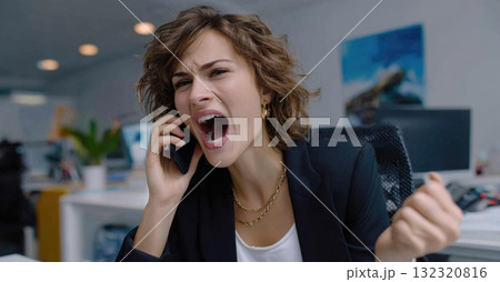 A person is excitedly celebrating business success on a phone call in an office setting. The energy reflects a significant achievement, embodying victory and team spirit, while holding a trophy. 132320816