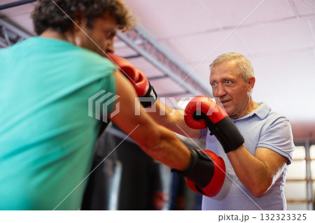 Two men boxing - boxing in gym Two men boxing - boxing in gym 132323325