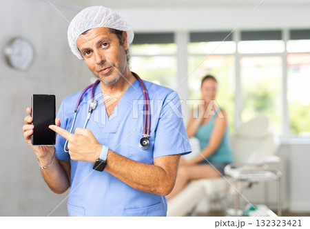 Doctor holding smartphone Doctor holding smartphone 132323421