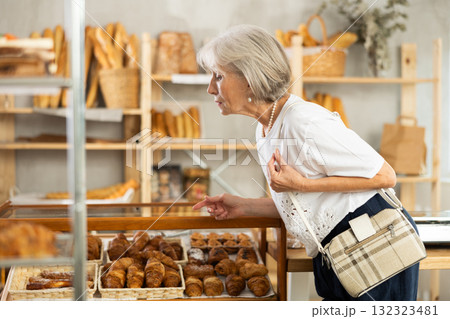 Elderly woman choosing pastries in bakery 132323481