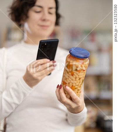 Adult woman scanning qr code of beans 132323580