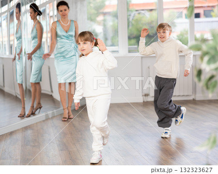 Boy and girl train to dance contemporary vigorous hip hop during classes. Boy and girl train to dance contemporary vigorous hip hop during classes. 132323627