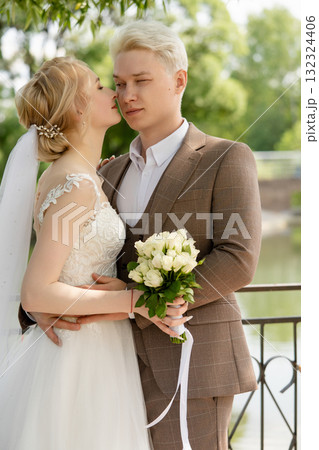 Couple shares an intimate moment during their outdoor wedding ceremony Couple shares an intimate moment during their outdoor wedding ceremony 132324406