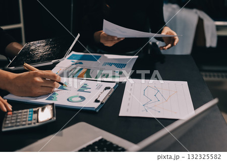 Accounting company provide finance and taxation planning for profitable cash flow, Auditor and accountant team working in office, analyze financial data and accounting record with calculator.Insight Accounting company provide finance and taxation planning for profitable cash flow, Auditor and accountant team working in office, analyze financial data and accounting record with calculator.Insight 132325582