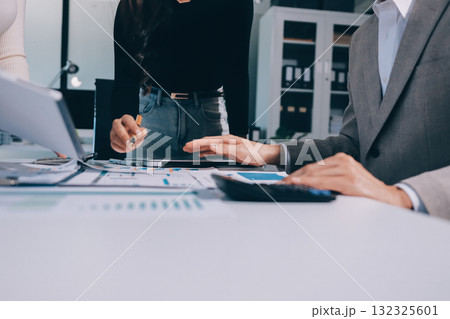 Accounting company provide finance and taxation planning for profitable cash flow, Auditor and accountant team working in office, analyze financial data and accounting record with calculator.Insight 132325601