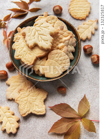 Autumn cookies in bowl with fall leaves and hazelnuts 132325817