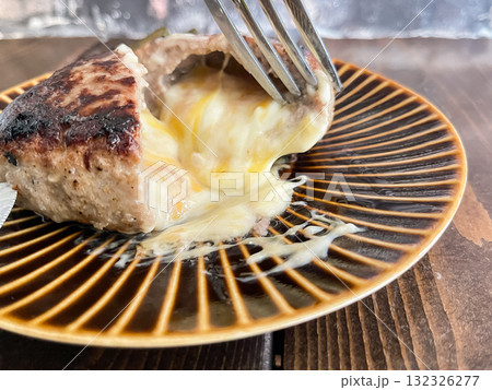 チーズハンバーグ。カットした断面からチーズがとろけ出るハンバーグ。 132326277
