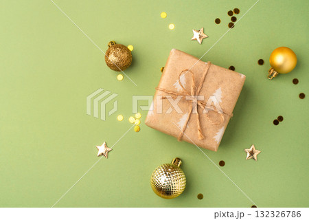 Christmas gift with ornaments on a green background 132326786