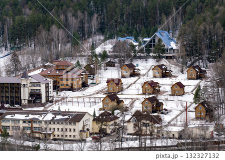 A tourist base nestled among the trees in the mountains in winter. A tourist base nestled among the trees in the mountains in winter. 132327132