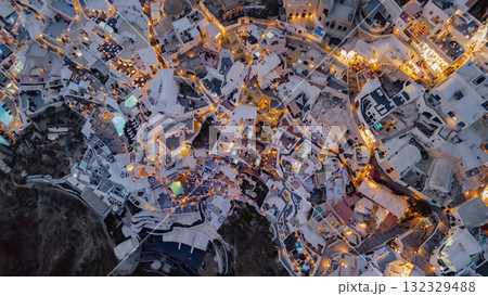 Aerial photo capturing the vibrant nightlife and unique building structure of a cliffside town Aerial photo capturing the vibrant nightlife and unique building structure of a cliffside town 132329488