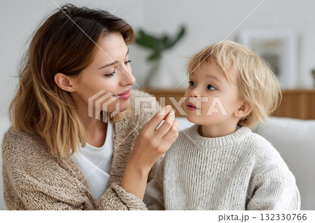 Happy Mother and Child Holding Vitamin Capsules Bottle Happy Mother and Child Holding Vitamin Capsules Bottle 132330766