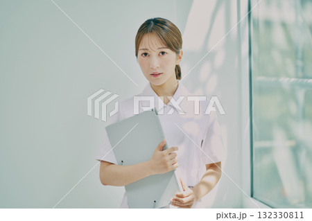窓際に立っている女性看護師 窓際に立っている女性看護師 132330811