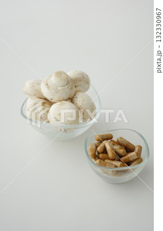 Fresh mushrooms and dietary supplements on a white surface 132330967