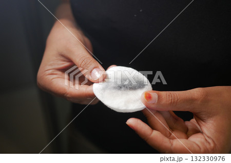 Clean cotton pad showing makeup removal process at home Clean cotton pad showing makeup removal process at home 132330976