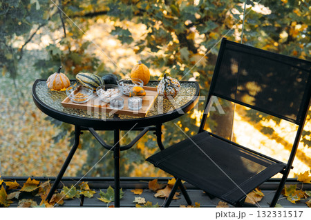 Glass table setup with bowls of supplements and decorative gourds arranged on a wooden tray surrounded by autumn leaves. Seasonal supplementation for immune resilience, fall immunity Glass table setup with bowls of supplements and decorative gourds arranged on a wooden tray surrounded by autumn leaves. Seasonal supplementation for immune resilience, fall immunity 132331517
