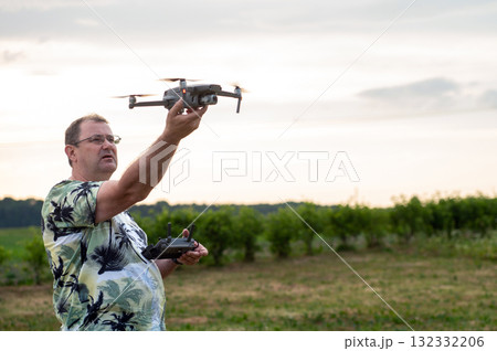 A drone lands on the hand of a man after a successful flight. A drone lands on the hand of a man after a successful flight. 132332206
