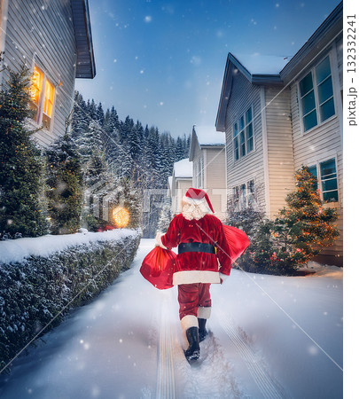 Santa claus delivering presents during christmas night Santa claus delivering presents during christmas night 132332241