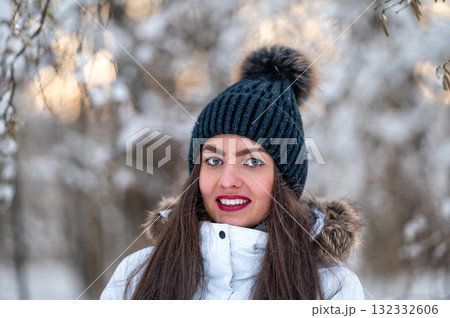young female walking in the snowy winter day outdoor, winter forest landscape background 132332606
