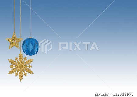 Christmas blue white gradient background with Christmas tree decorations with a golden snowflake, star and ball with copy space. New Year and Christmas card. Christmas blue white gradient background with Christmas tree decorations with a golden snowflake, star and ball with copy space. New Year and Christmas card. 132332976