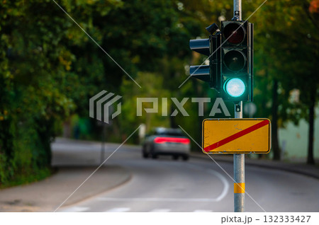 traffic semaphore with green light on defocused background of autumn city, closeup 132333427