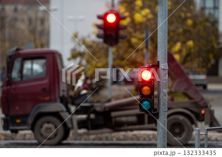 view of city traffic with traffic lights, in the foreground a traffic light with a red light 132333435