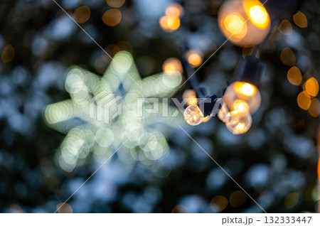 garland of light bulbs on defocused festive lights background, shallow depth of field, copy space garland of light bulbs on defocused festive lights background, shallow depth of field, copy space 132333447