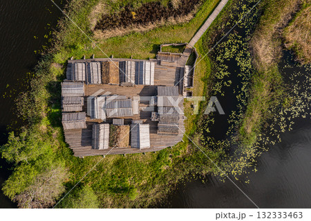 view from above of ancient wooden settlement on river island, recontruction of ancient architecture 132333463