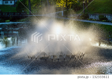 Fountain in the evening sunlight in Kuld?ga city park, Latvia Fountain in the evening sunlight in Kuld?ga city park, Latvia 132333611