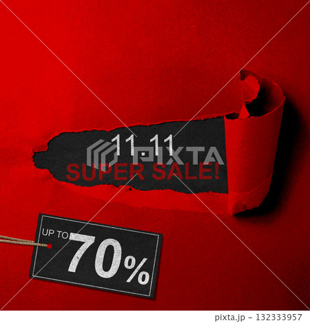 Top view of red ripped paper and text of 11.11 super sale with up to 70% text on the label tag. Copy space. Flash sale concept 132333957