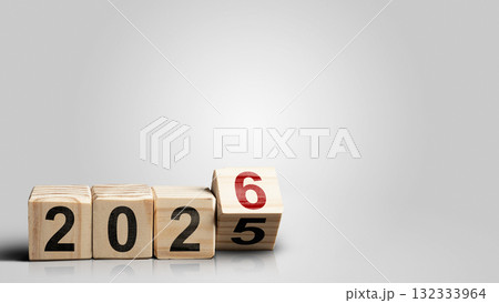 Wooden cubes transform from the number 2025 to 2026 on a white background. Happy New Year concept or Celebration 132333964