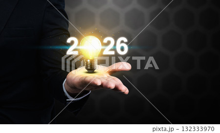Business hand showing 2026 with a bright light bulb. Happy New Year concept or Celebration Business hand showing 2026 with a bright light bulb. Happy New Year concept or Celebration 132333970