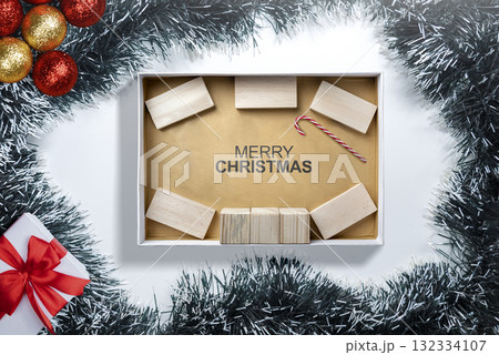 Greeting of Merry Christmas text with a wooden block and a candy cane in a giftbox. Mockup or Copy space. Holiday greetings or winter themes. Concept of the Merry Christmas celebration Greeting of Merry Christmas text with a wooden block and a candy cane in a giftbox. Mockup or Copy space. Holiday greetings or winter themes. Concept of the Merry Christmas celebration 132334107