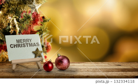 Greeting card of Merry Christmas with Christmas ornaments on the table with a blurred bokeh lights background. Holiday greetings or winter themes. Concept of the Merry Christmas celebration Greeting card of Merry Christmas with Christmas ornaments on the table with a blurred bokeh lights background. Holiday greetings or winter themes. Concept of the Merry Christmas celebration 132334118