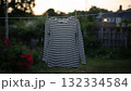 Striped Shirt Hanging on Line in a Beautiful Garden Setting 132334584
