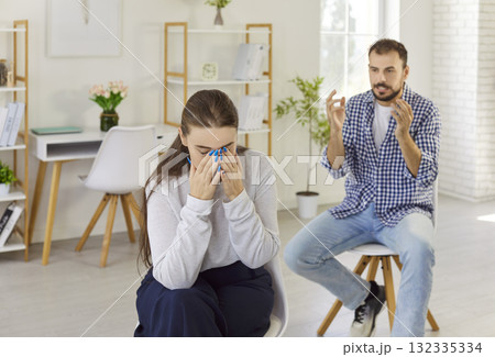 Couple in conflict and breakup quarrel at home, crying upset woman hiding face 132335334