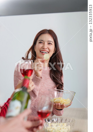 Enjoying Snacks and Drinks During Happy New Year Enjoying Snacks and Drinks During Happy New Year 132335913