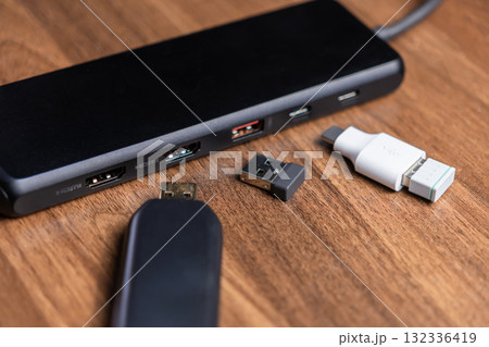 Black USB-C multi-port hub with HDMI and USB connections, featuring various adapters for expanded modern device connectivity 132336419