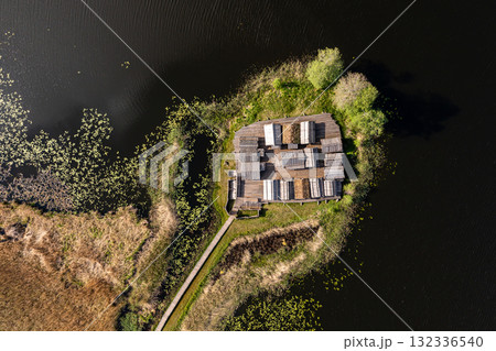view from above of ancient wooden settlement on river island, recontruction of ancient architecture view from above of ancient wooden settlement on river island, recontruction of ancient architecture 132336540