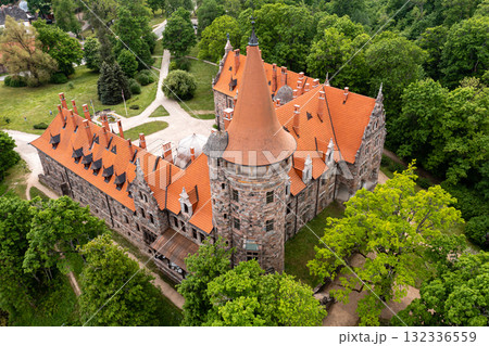 Cesvaine medieval castle in Latvia from above. Building of stones with a brown tiled roof. Cesvaine medieval castle in Latvia from above. Building of stones with a brown tiled roof. 132336559